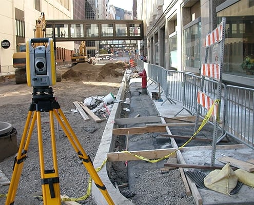 survey equipment on roadway under construction