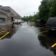 Newly paved parking lot with vehicles and building