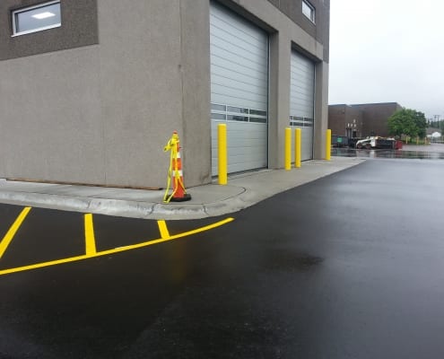 Newly paved parking lot with building in the background