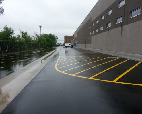 Newly paved parking lot with van in the background